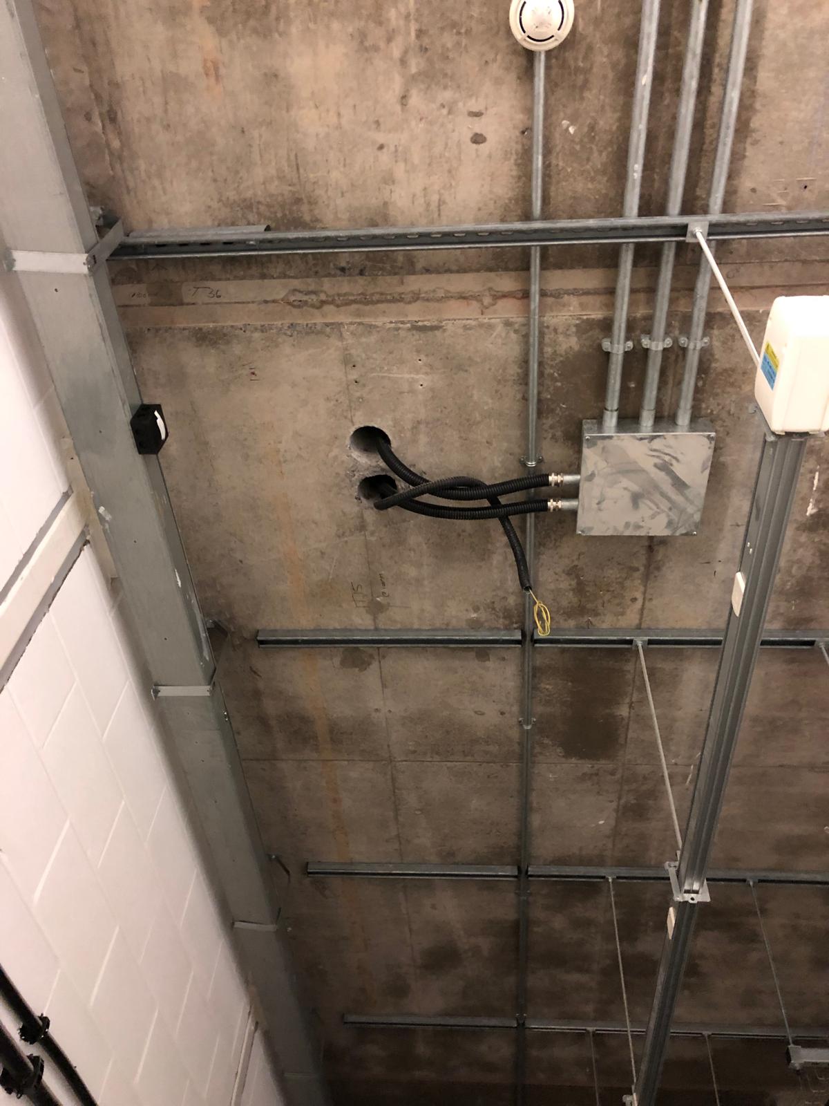 Core drilled ceiling penetrations with conduits